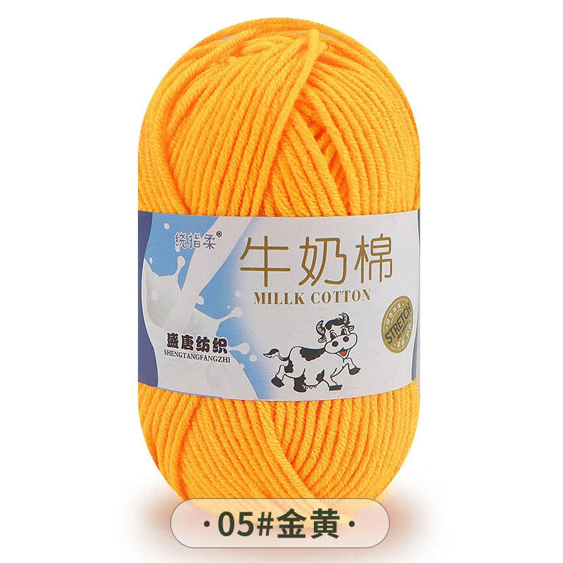 A ball of bright orange milk cotton yarn labeled with Chinese characters and a product code.