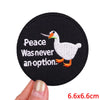 Black embroidered patch featuring a white duck with orange feet and text that reads Peace Was never an option