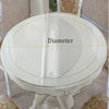 A round white waterproof PVC tablecloth with a decorative print is shown on a table.