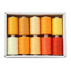A box containing ten spools of colored polyester sewing thread, including shades of yellow, orange, and red.