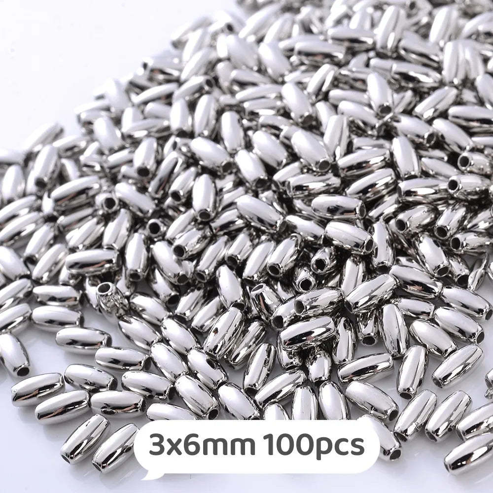 A pile of silver metallic beads, 3x6mm size, for jewelry making.