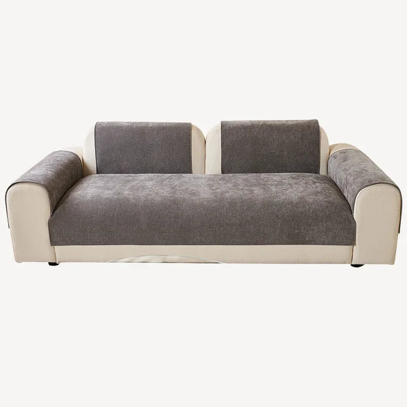 A modern sofa featuring light beige trim and charcoal gray chenille cushions.
