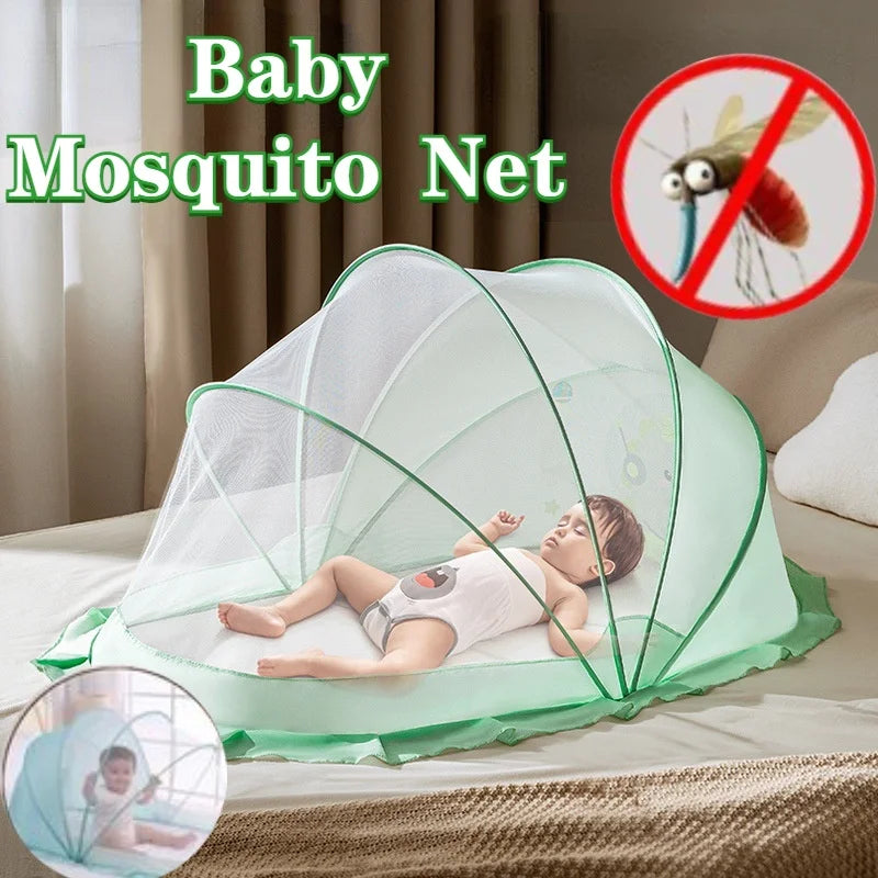A baby is sleeping inside a light green foldable mosquito net designed for infant cribs.