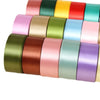 A collection of colorful satin ribbon rolls in various shades arranged in a row.