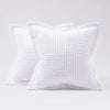 A white striped corduroy lumbar support pillow cushion shown in a close-up view.