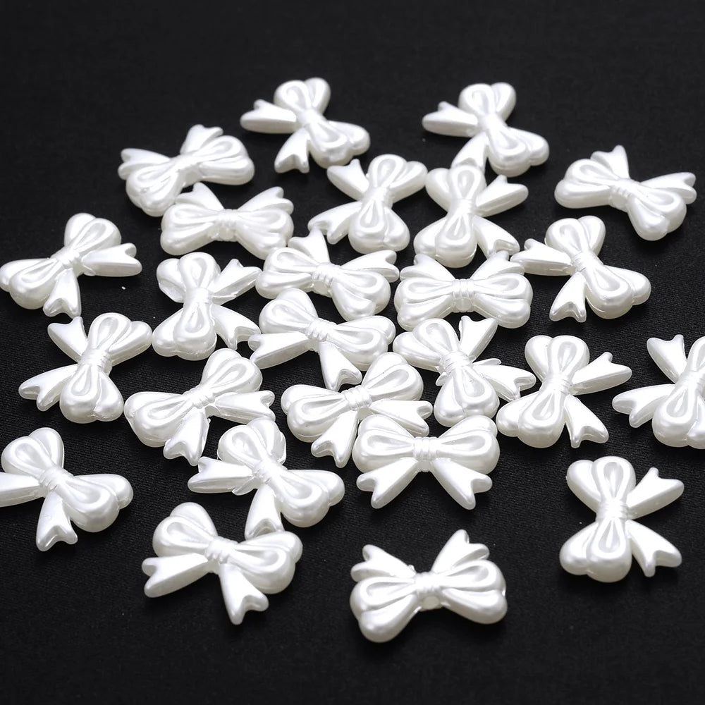A pile of small white imitation pearl flower spacer beads for DIY jewelry