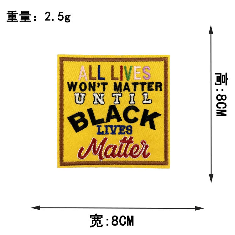 A yellow embroidered patch with black text that reads All Lives Won't Matter Until Black Lives Matter