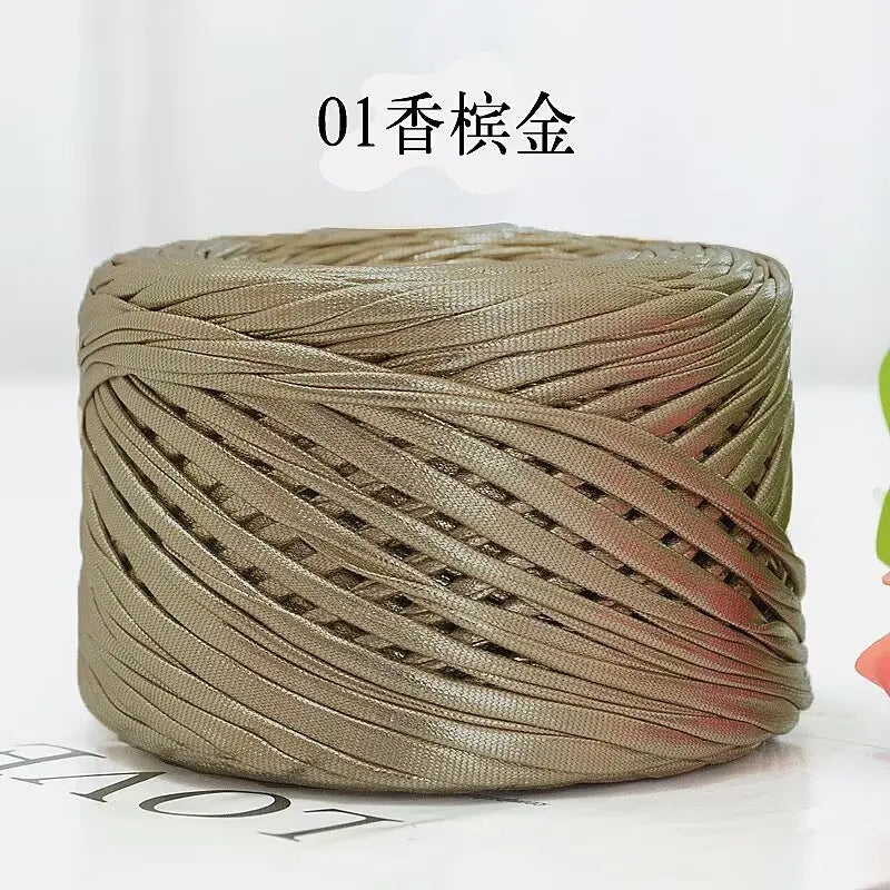 A ball of metallic gold cake yarn used for crafting.