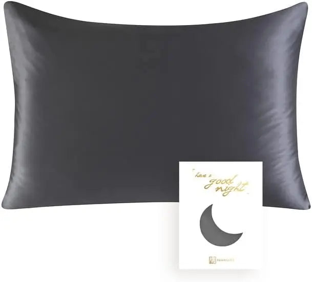 A dark gray silk pillowcase with a subtle gold text message on the front.