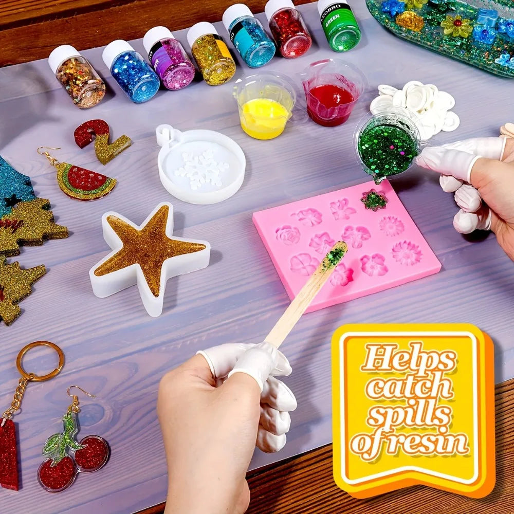 A hand is shown using a silicone crafting mat to help catch spills of resin during a craft activity.