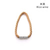 A braided natural fiber tieback clip with a silver magnetic closure.