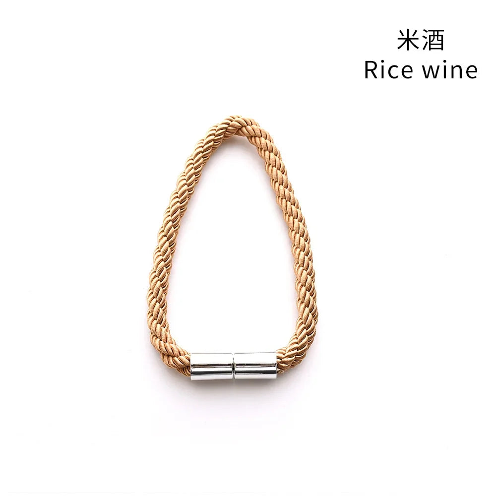 A braided natural fiber tieback clip with a silver magnetic closure.