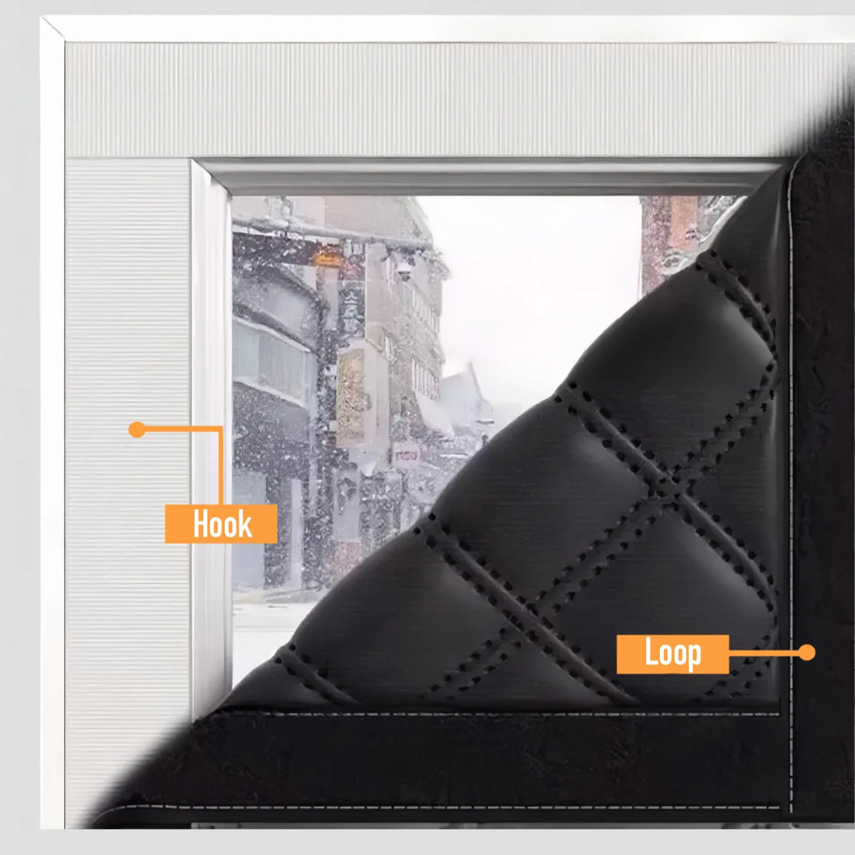A close-up of a black thermal window film with a hook and loop for insulation.