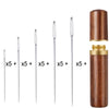 A set of 25 large eye hand sewing needles with sharp points stored in a wooden cylindrical case.