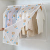A transparent garment dust cover is shown protecting hanging clothes on a rod.