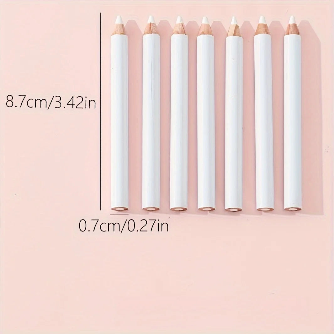 A row of white bamboo chalk pencils with pointed tips displayed against a pink background.