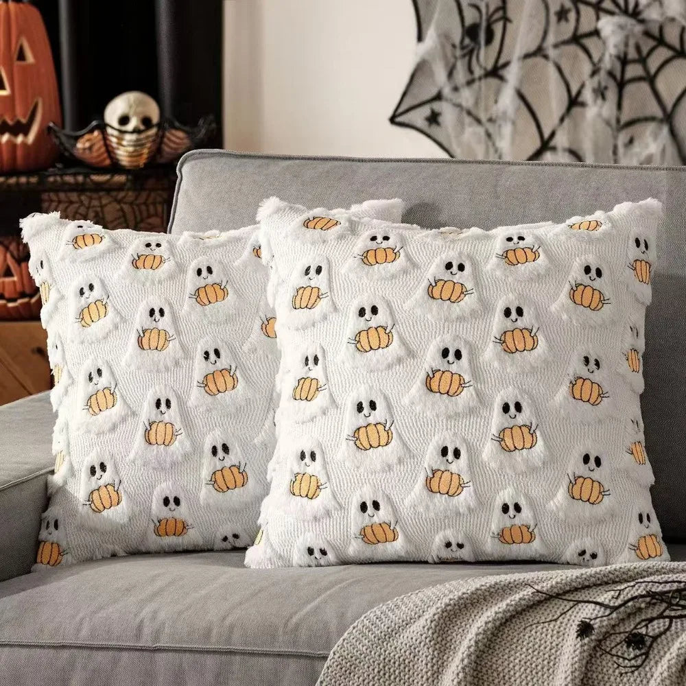 White throw pillow cover featuring a pattern of small yellow ghost and pumpkin designs.