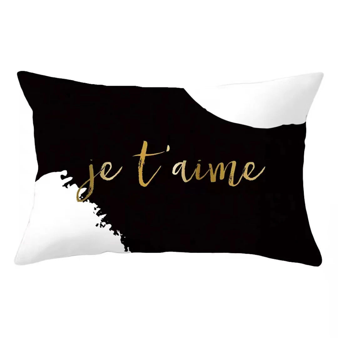 Black pillow cover with white text that reads je t'aime