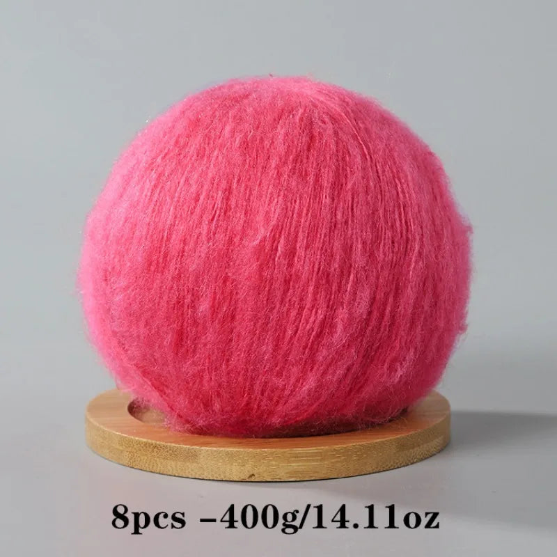 A ball of bright pink mohair yarn used for crafting.