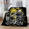 A black blanket featuring a graphic design of a stylized, intense character with yellow and gray tones.