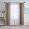A set of beige sheer and blackout window drapes hanging on a rod in a light blue room.