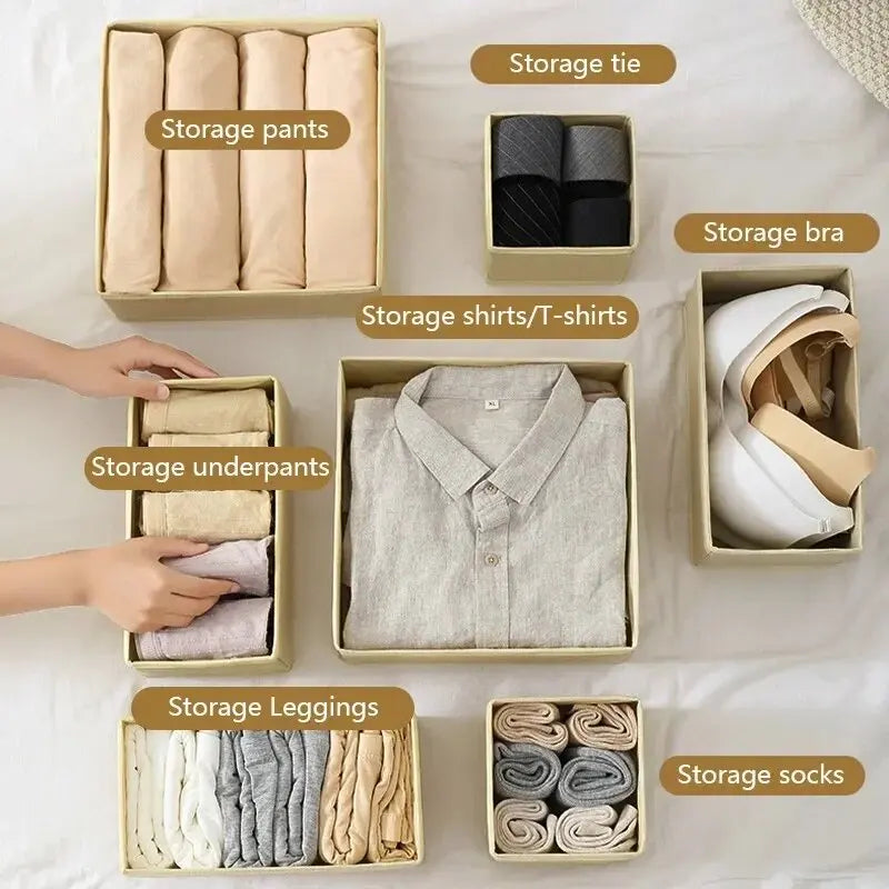 A collection of neatly folded underwear, shirts, pants, leggings, and socks organized in individual storage boxes.