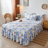 A double layer printed bed skirt featuring blue and white floral patterns on a bed.