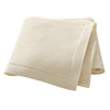 A folded cream colored all-season cotton baby swaddle blanket.