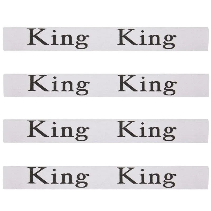 A set of four white elastic bed sheet organizer straps, each labeled King.