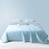 Light blue ice silk summer cooling blanket folded on a bed
