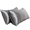 Two smooth gray luxury mulberry silk pillow covers lying flat