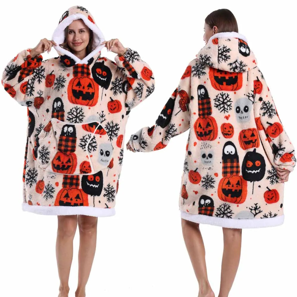 A woman models an oversized patchwork fleece hoodie featuring an orange and white Halloween pattern.