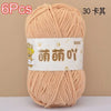 A skein of light peach colored soft bulky chenille yarn is shown, packaged with a label indicating 6 pieces and 30 balls.