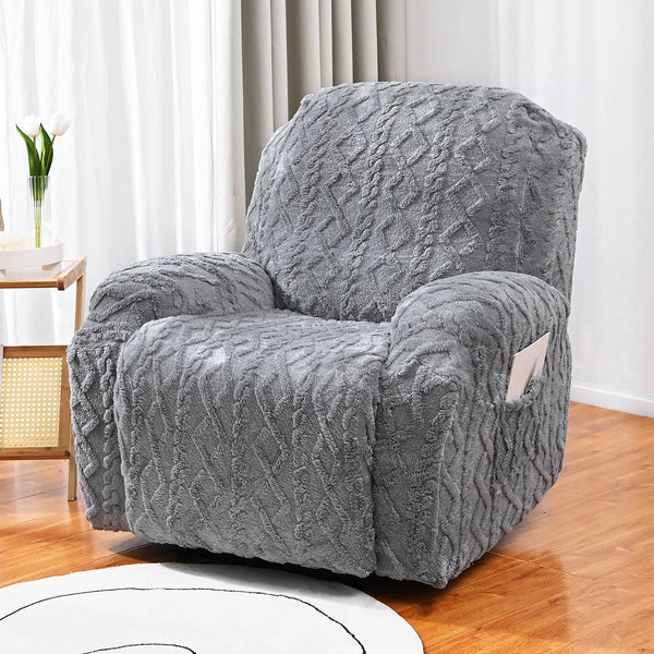 A gray textured armchair covered in a double-sided jacquard sofa cover set sitting on a wooden floor.