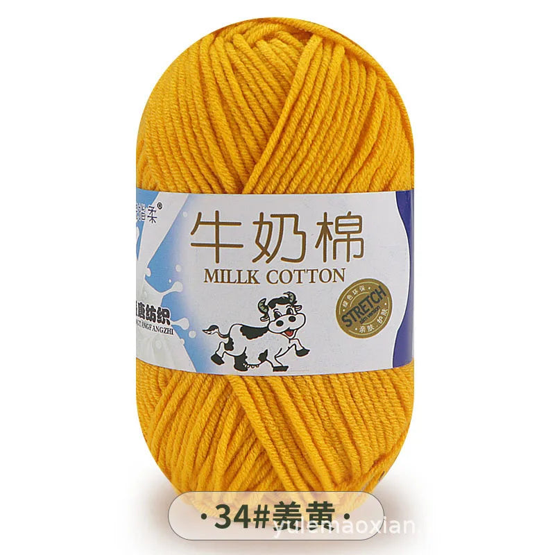 A ball of yellow milk cotton yarn labeled in Chinese and English.