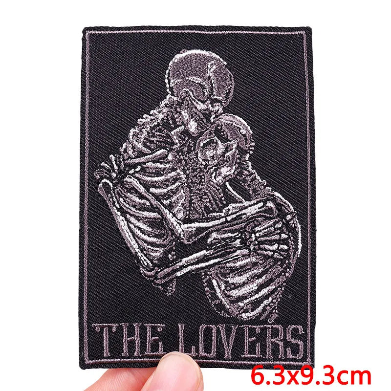 A black embroidery patch depicting a detailed skull and skeletal structure for clothing.