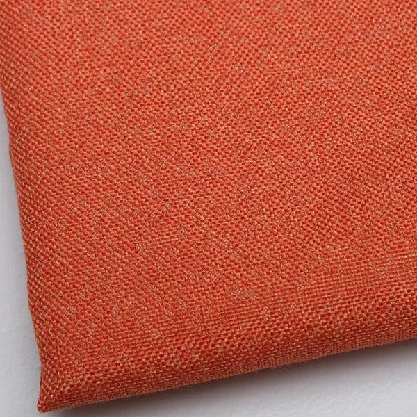 Close-up of coarse orange linen and cotton fabric texture.