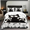 A black and white cat print bedding set featuring multiple cats on a duvet cover and pillows.