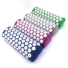 A set of five colorful acupressure relief mats and pillows in shades of green, purple, and blue.