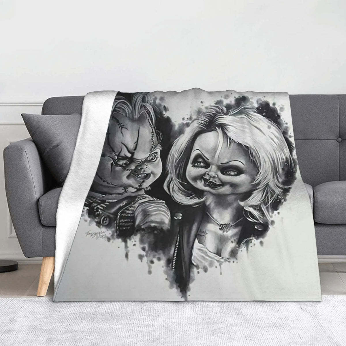 A flannel throw blanket featuring a distressed Chucky horror movie character design.