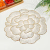 Gold plated peony coasters with delicate line art design on a white surface.