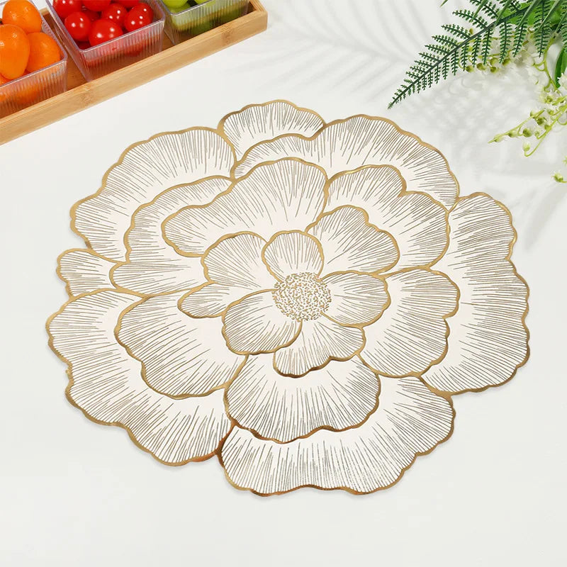 Gold plated peony coasters with delicate line art design on a white surface.