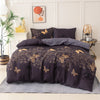 A dark purple butterfly print duvet cover set displayed on a bed with white and gold accents.