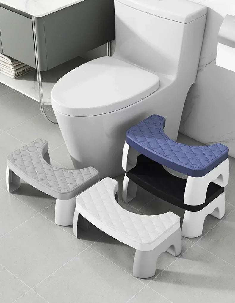 A white adjustable adult toilet squat stool with a blue seat is shown next to a modern toilet.