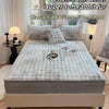A fitted sheet with rabbit fur texture is displayed on a bed, surrounded by natural light and white decor.