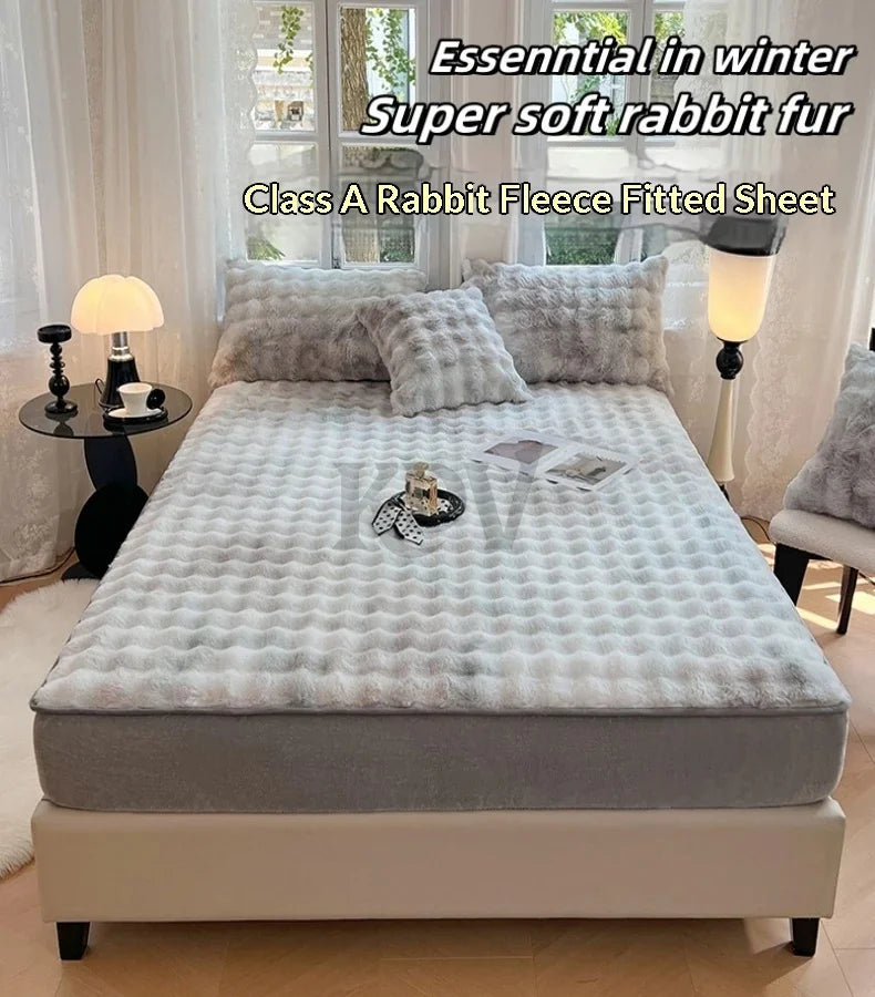 A fitted sheet with rabbit fur texture is displayed on a bed, surrounded by natural light and white decor.