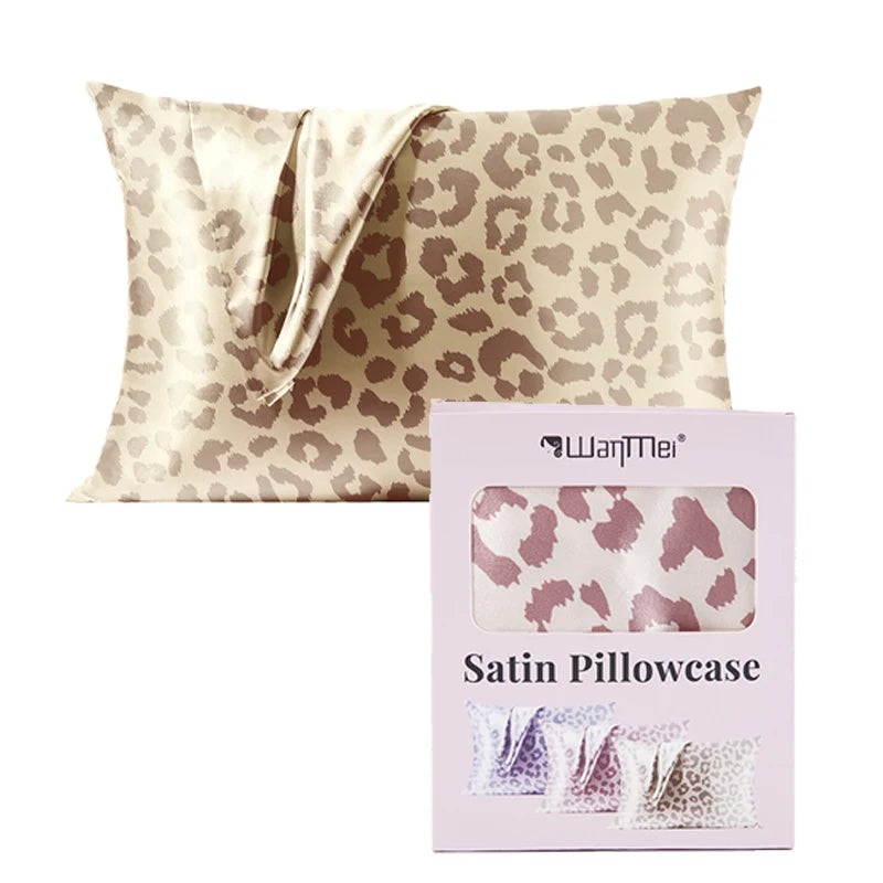 A pink leopard print satin pillowcase is shown next to its packaging.