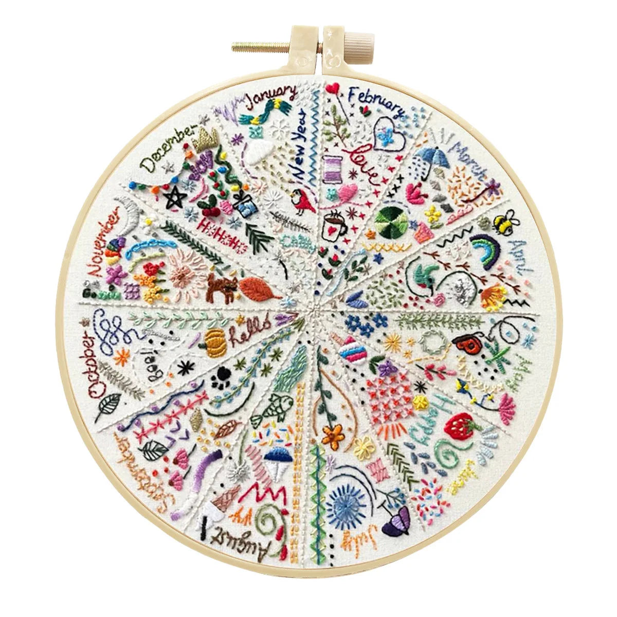 A circular embroidery kit featuring floral designs and months of the year, with a gold-colored wooden frame.