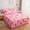 A pink and white checkered bed skirt with strawberry patterns on a white metal bed frame.