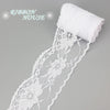A roll of white decorative lace ribbon for a house, featuring floral patterns.